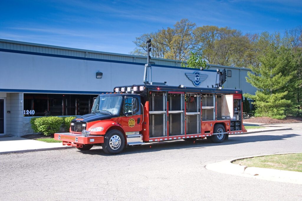 red fire trailer parked outside with black roof