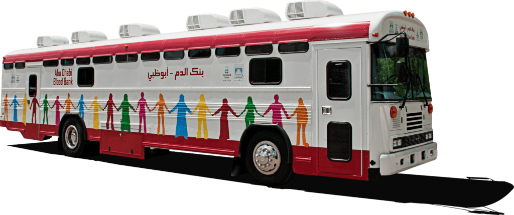 blood bank trailer, white and red with colorful stick figures on the side