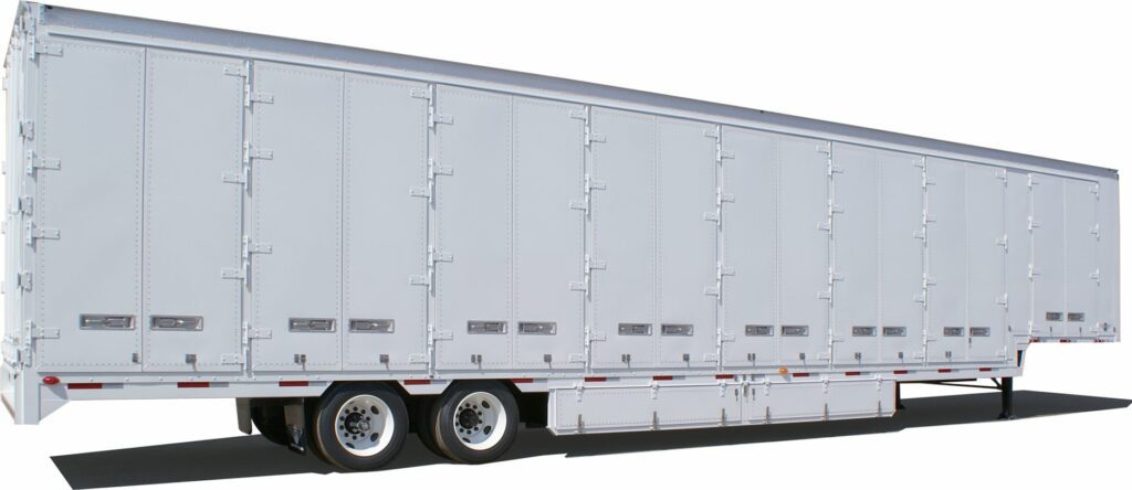 A large white semi-trailer with multiple sets of wheels is parked, displaying a clean, unmarked side panel.