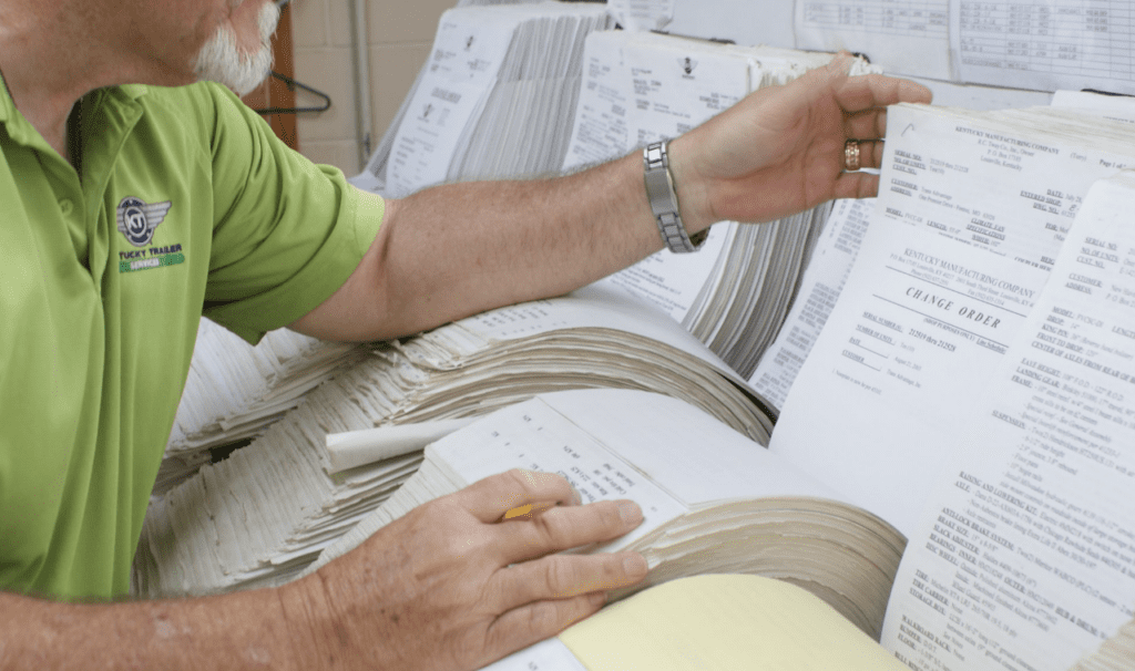 a man flipping through paperwork