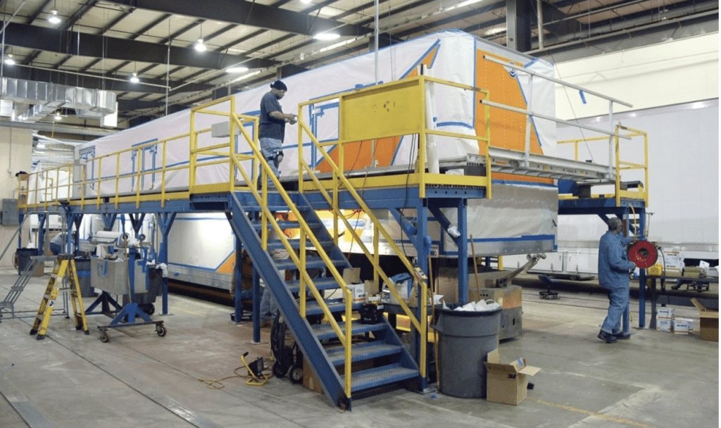 men in a factory working on a trailer
