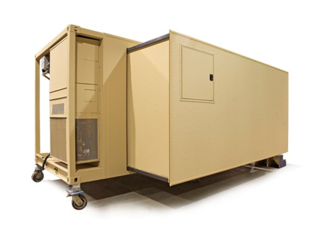 A portable beige cabin on wheels, possibly a movable office or construction site trailer.