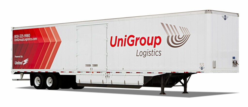 A white UniGroup Logistics truck is parked, displaying the company's logo and branding on its side.