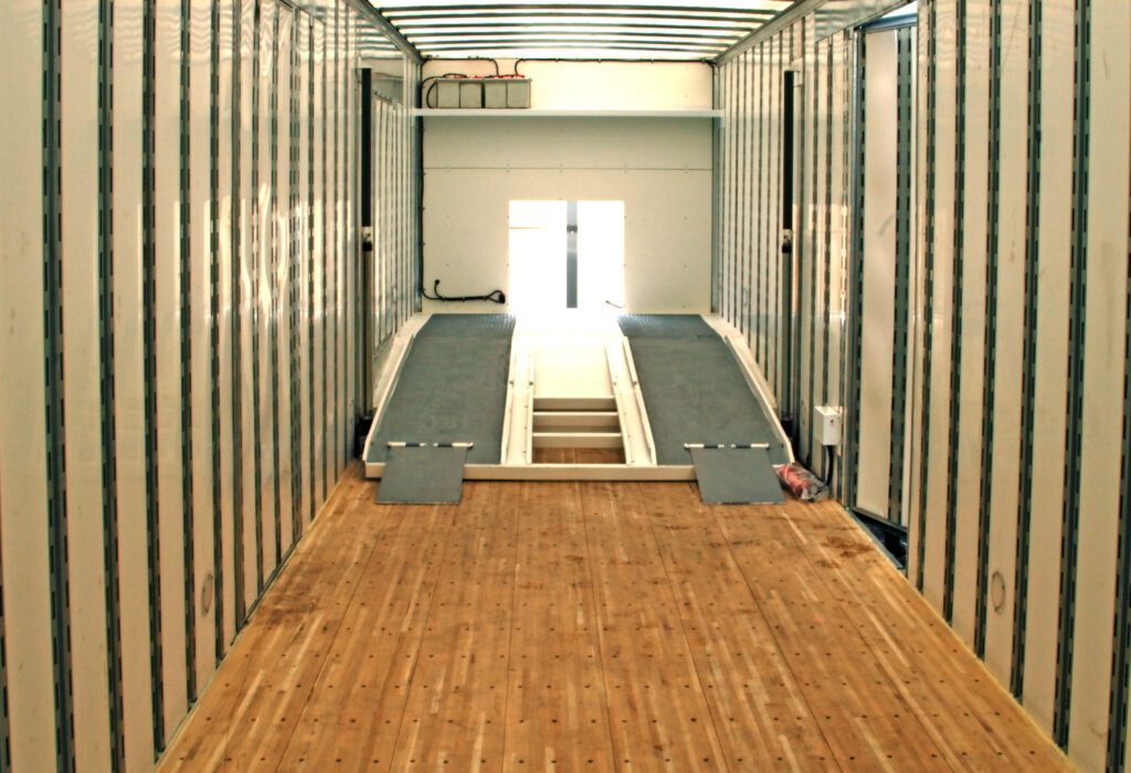 pivoting deck inside of the 2 car trailer