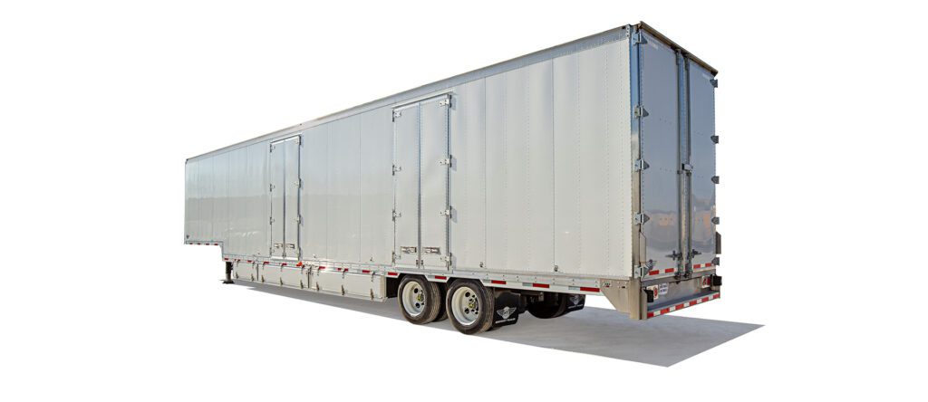 A large white semi-trailer truck is parked against a plain background, showcasing its side profile.