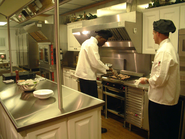 chefs in mobile kitchen trailer